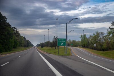 a highway with a weigh station sign